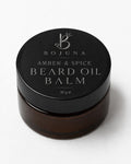 A 30g jar of Bojuna Amber & Spice Beard Oil Balm, featuring a black lid with silver lettering and a dark amber-brown glass container, set against a clean white background.