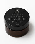 A 30g jar of Bojuna Pine & Cedar Beard Oil Balm, featuring a black lid with silver lettering and a dark amber-brown jar below, set against a clean white background.