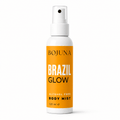 A 120 ml spray bottle of BOJUNA Brazil Glow Alcohol Free Body Mist, featuring a white bottle and cap with a vibrant orange label.