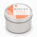 A round silver metal tin candle with a white lid label featuring peach and orange abstract graphics and the text 'BOJUNA Peach SCENTED CANDLE'.