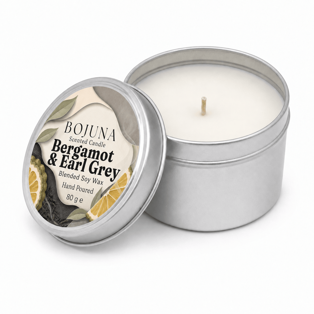 An open silver metal tin candle with white wax and a single wick, shown beside its matching lid on a clean white background. The label reads BOJUNA Scented Candle Bergamot & Earl Grey.