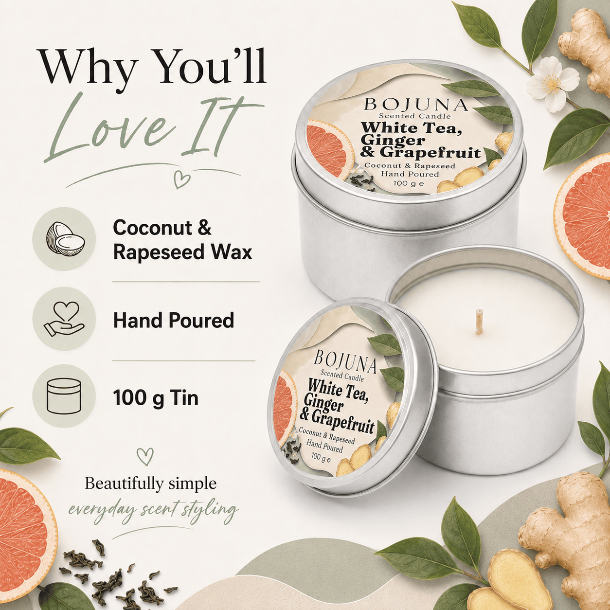 Two silver tin candles from BOJUNA Scents are displayed on a light cream background with decorative botanical and citrus props. One tin is open, showing white wax, while the other is closed with its label facing up.