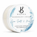 A round white plastic tub of Bojuna Deodorant Cream in the Sea Salt & Mint scent, featuring a white lid with blue watercolor splash designs and black text.