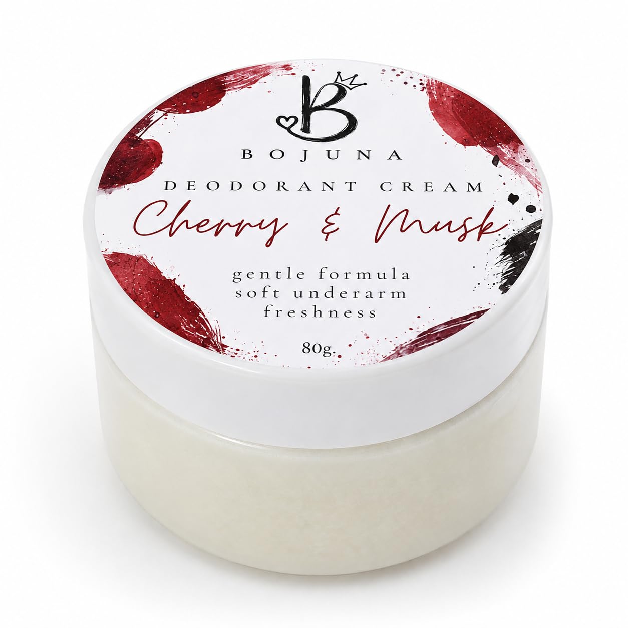 A jar of Bojuna Deodorant Cream in the Cherry & Musk scent, featuring a white lid with red and black paint splatter designs and a white jar of cream underneath, shot against a white background.