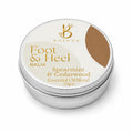 A round silver metal tin of Bojuna Foot & Heal Balm, featuring a cream-colored label with gold text and a brown color swatch on a white background.