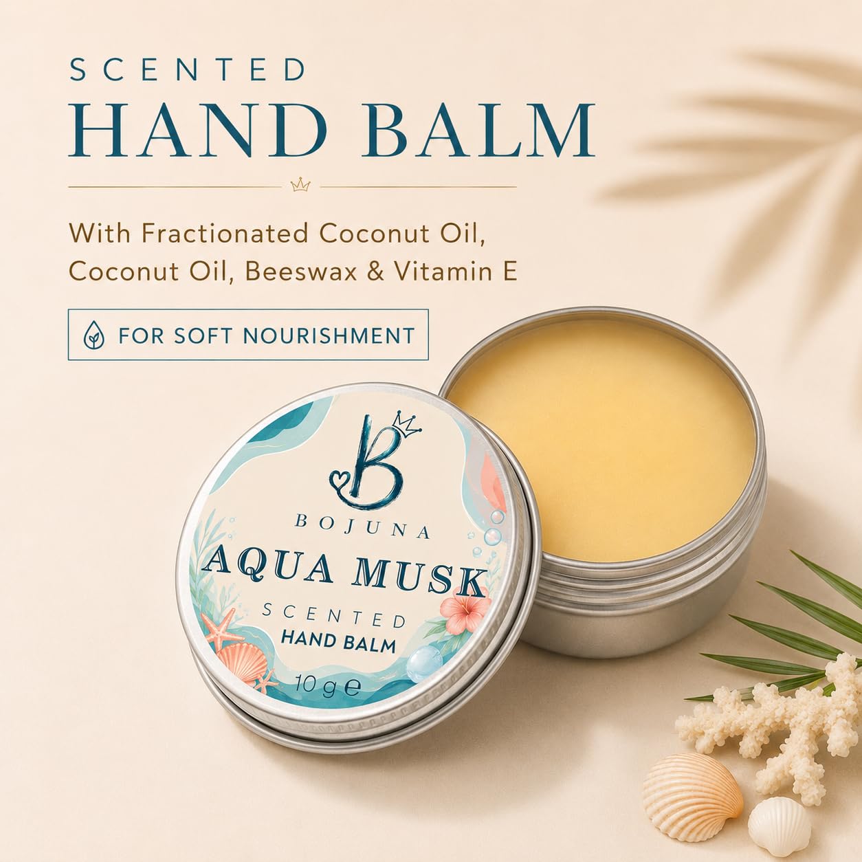 Bojuna Aqua Musk Scented Hand Balm in a round silver tin, shown open with the pale yellow balm visible next to the decorated lid. The image is set on a warm beige background with decorative text and small seashell and leaf props.