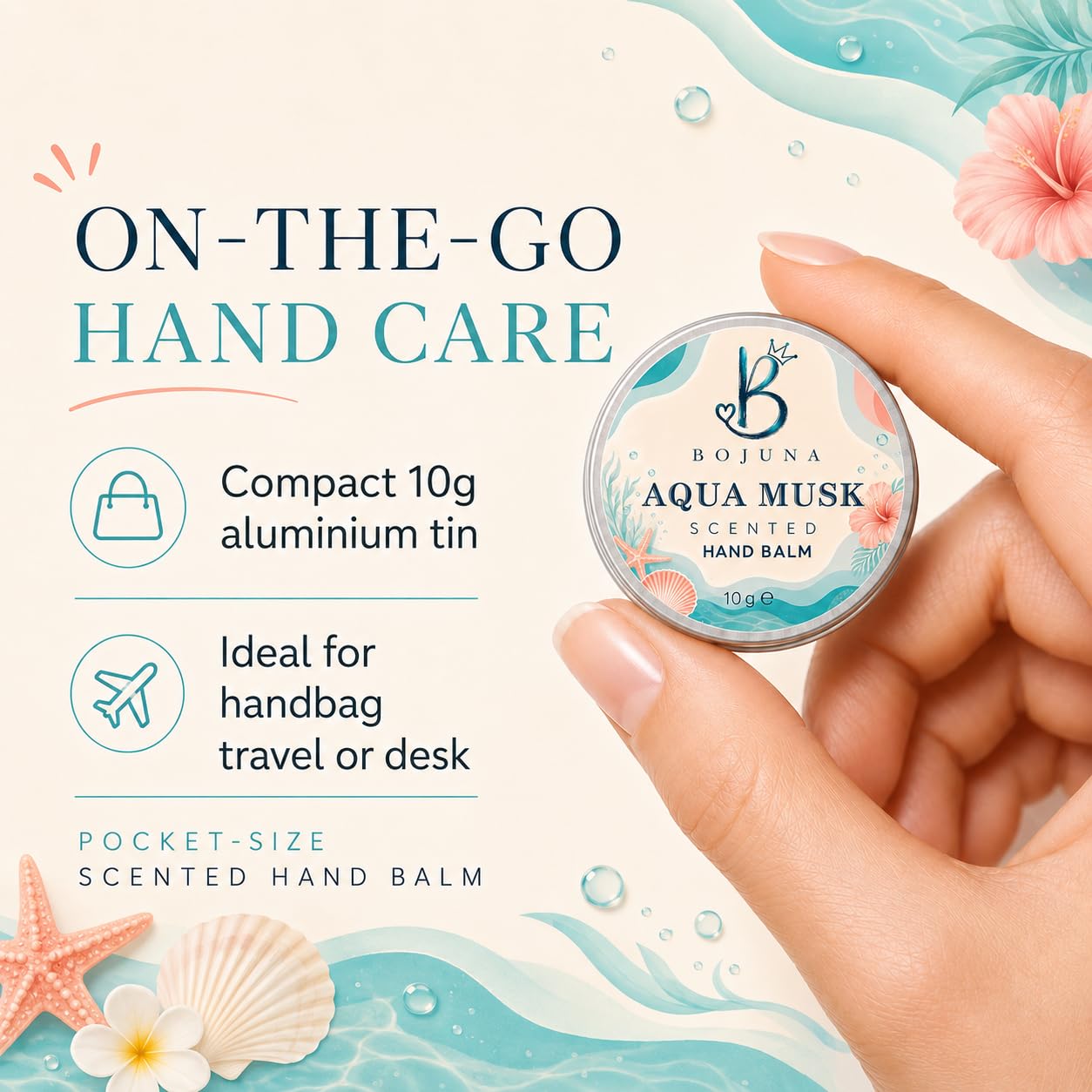 A hand holds a small round tin of Bojuna Aqua Musk Scented Hand Balm against a tropical beach-themed graphic background with turquoise waves, pink flowers, shells, and text reading 'ON-THE-GO HAND CARE' and 'Compact 10g aluminium tin. Ideal for handbag travel or desk.