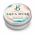 A round silver metal tin of Bojuna Aqua Musk Scented Hand Balm, featuring a colorful tropical-themed label with blue, pink, and teal illustrations on a white background.
