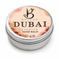 A round silver metal tin of Bojuna Dubai Scented Hand Balm, 10g, featuring a peach and pink label with botanical illustrations.