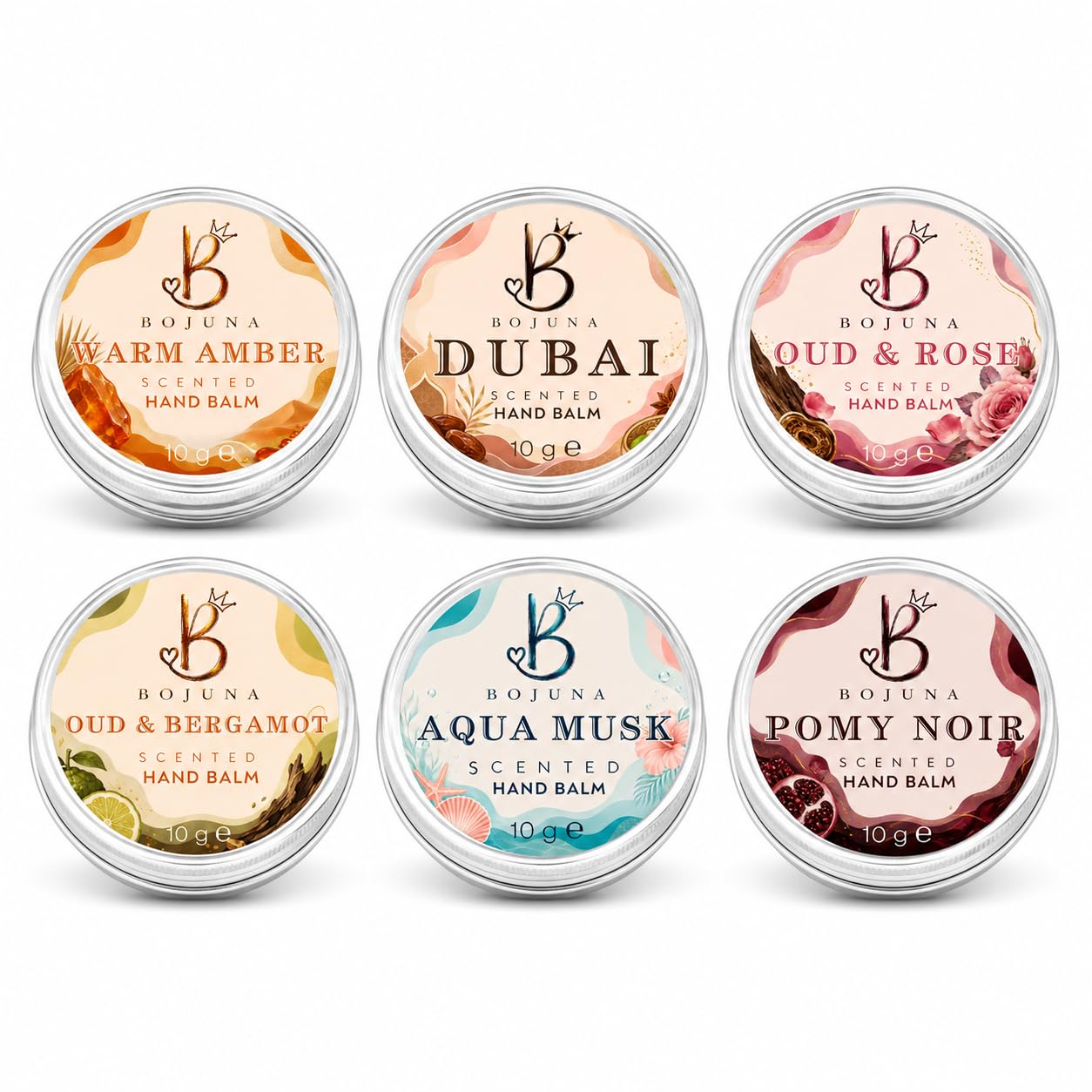 Six round silver metal tins of Bojuna scented hand balm arranged in two rows on a white background. The top row shows Warm Amber, Dubai, and Oud & Rose; the bottom row shows Oud & Bergamot, Aqua Musk, and Pomy Noir.