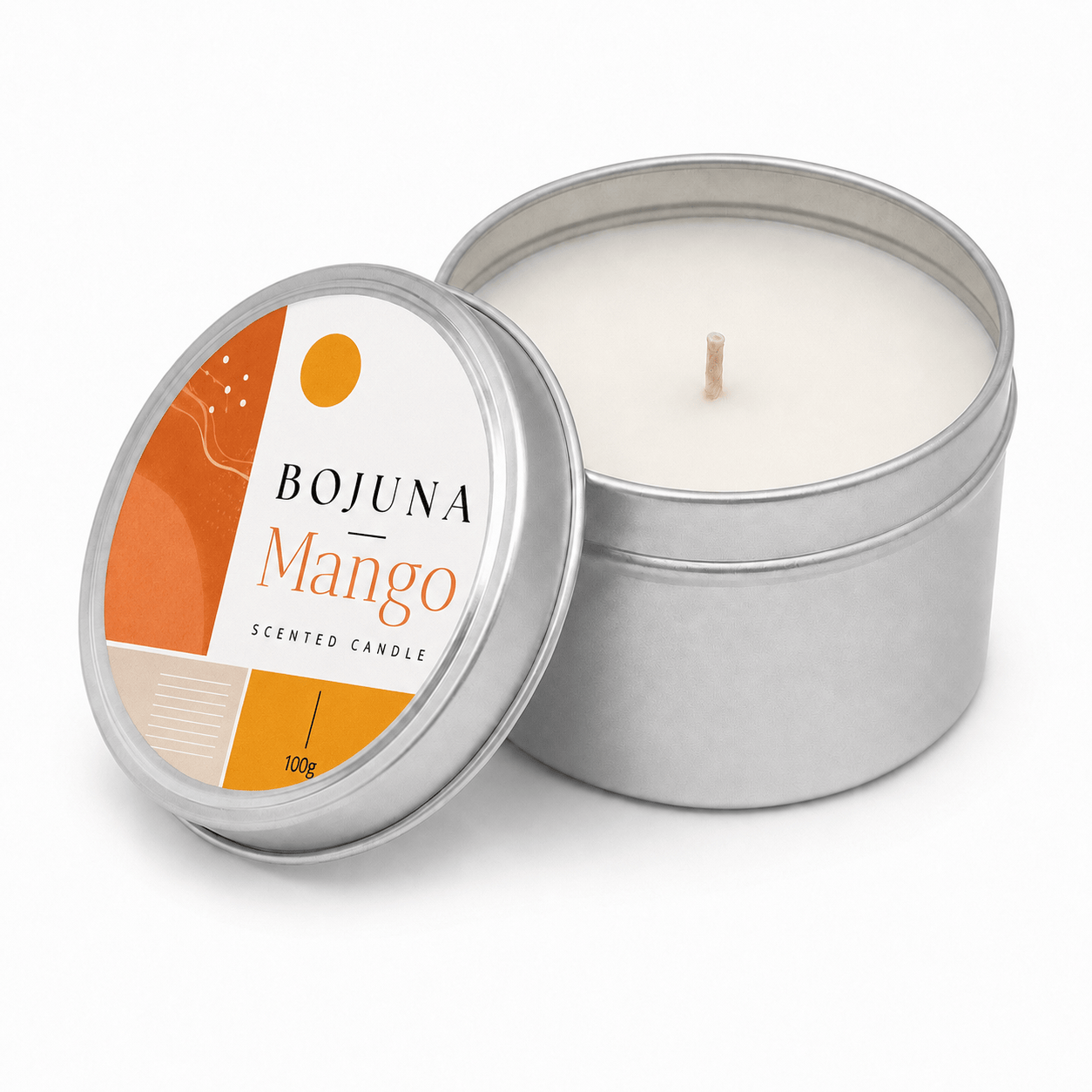 An open silver metal tin candle with white wax and a single wick, next to its lid. The lid features a white and orange label with the brand name BOJUNA and the scent name Mango.