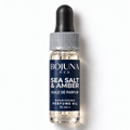 Bojuna Men Sea Salt & Amber nourishing perfume oil 10 ml, lying flat on white with a navy label, white first scent line and grey dropper cap.