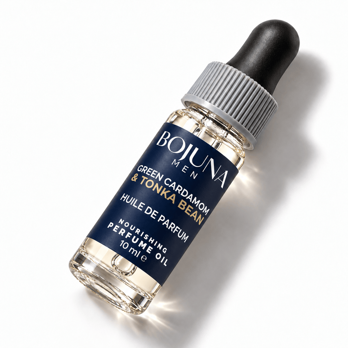 Bojuna Men Green Cardamom & Tonka Bean nourishing perfume oil 10 ml, lying diagonally on white with a navy label, white first scent line and grey dropper cap.