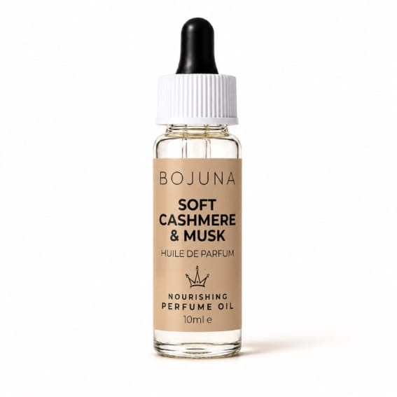 A 10ml bottle of BOJUNA Soft Cashmere & Musk Nourishing Perfume Oil, featuring a beige label, clear glass bottle, white cap, and black dropper, set against a plain white background.