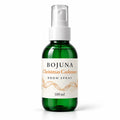 Bojuna Christmas Cashmere Room Spray 100 ml, green bottle with white atomiser and Christmas wrap label.