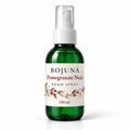 Bojuna Pomegranate Noir Room Spray 100 ml, green bottle with white atomiser and Christmas wrap label.