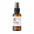 An amber glass room spray bottle with a black spray nozzle and a white label reading 'Bojuna Travel Size Room Spray' and 'Sunset Blossom', shown on a plain white background.