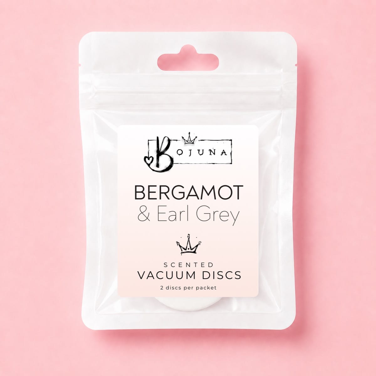 A white resealable pouch of Bojuna Scented Vacuum Discs in the Bergamot & Earl Grey scent, shown on a solid pink background.