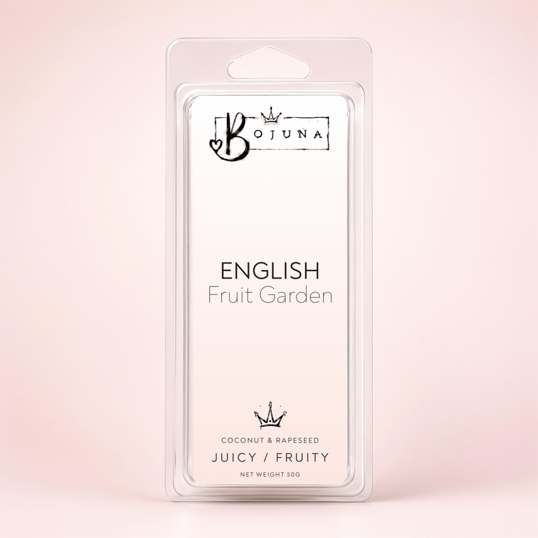 Bojuna English Fruit Garden wax melts in a clear plastic clamshell package with a white insert card, set against a soft pink background.