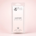 A clear plastic clamshell package containing a white wax melt or fragrance melt card labeled BOJUNA Leather & Rich Musk, photographed against a soft pale pink background.