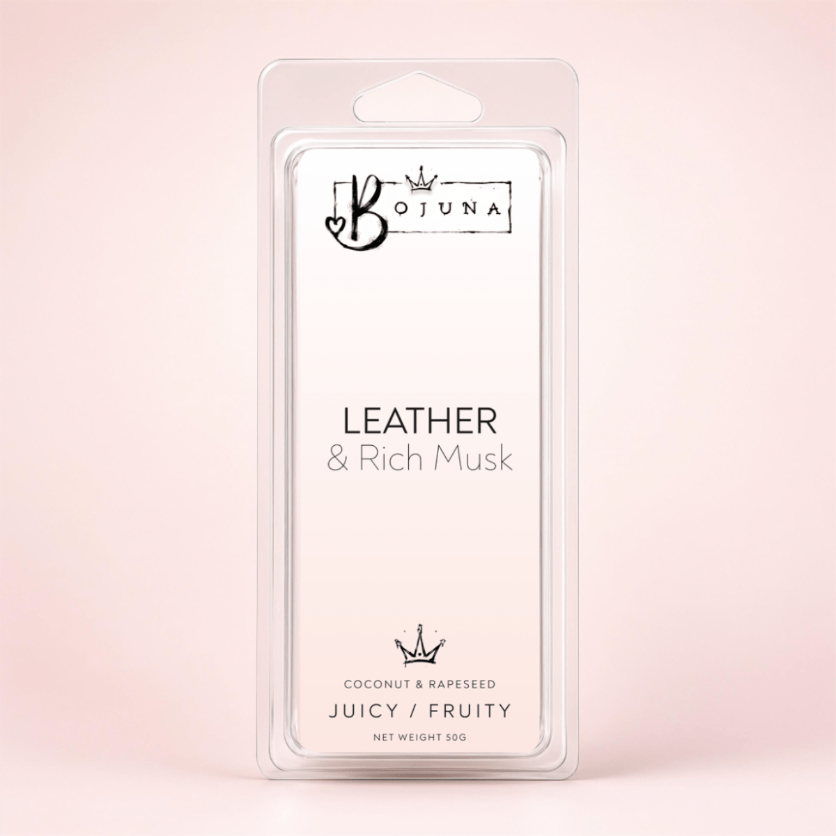 A clear plastic clamshell package containing a white wax melt or fragrance melt card labeled BOJUNA Leather & Rich Musk, photographed against a soft pale pink background.